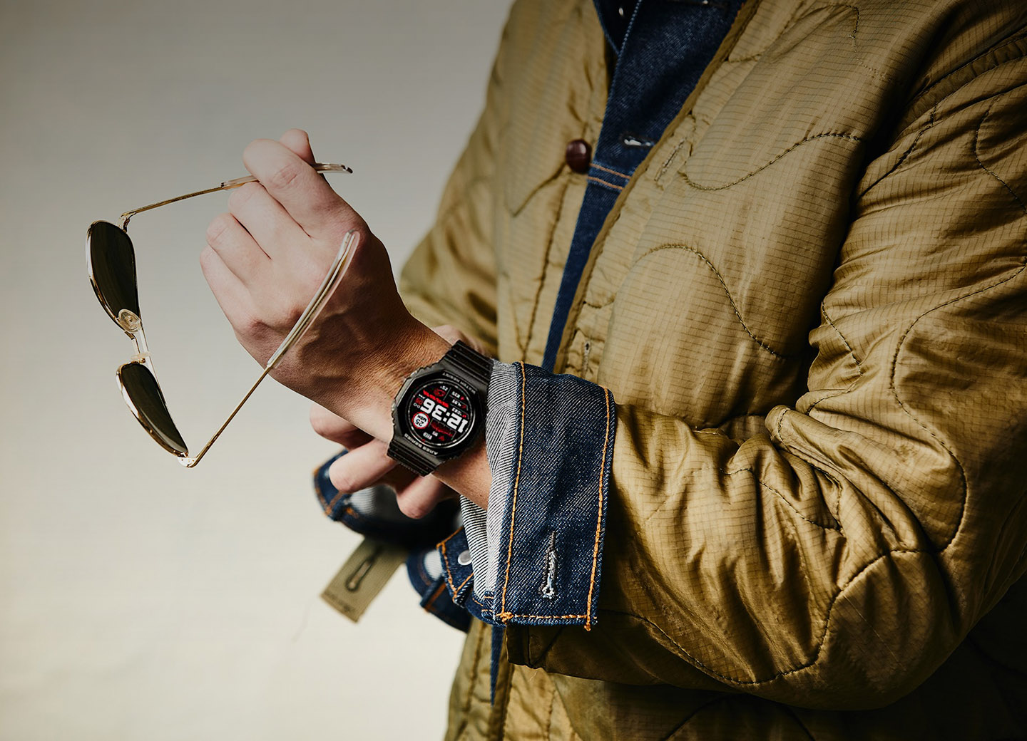 Smartwatch Zeblaze Ares 2 on the hand of a man in a yellow jacket
