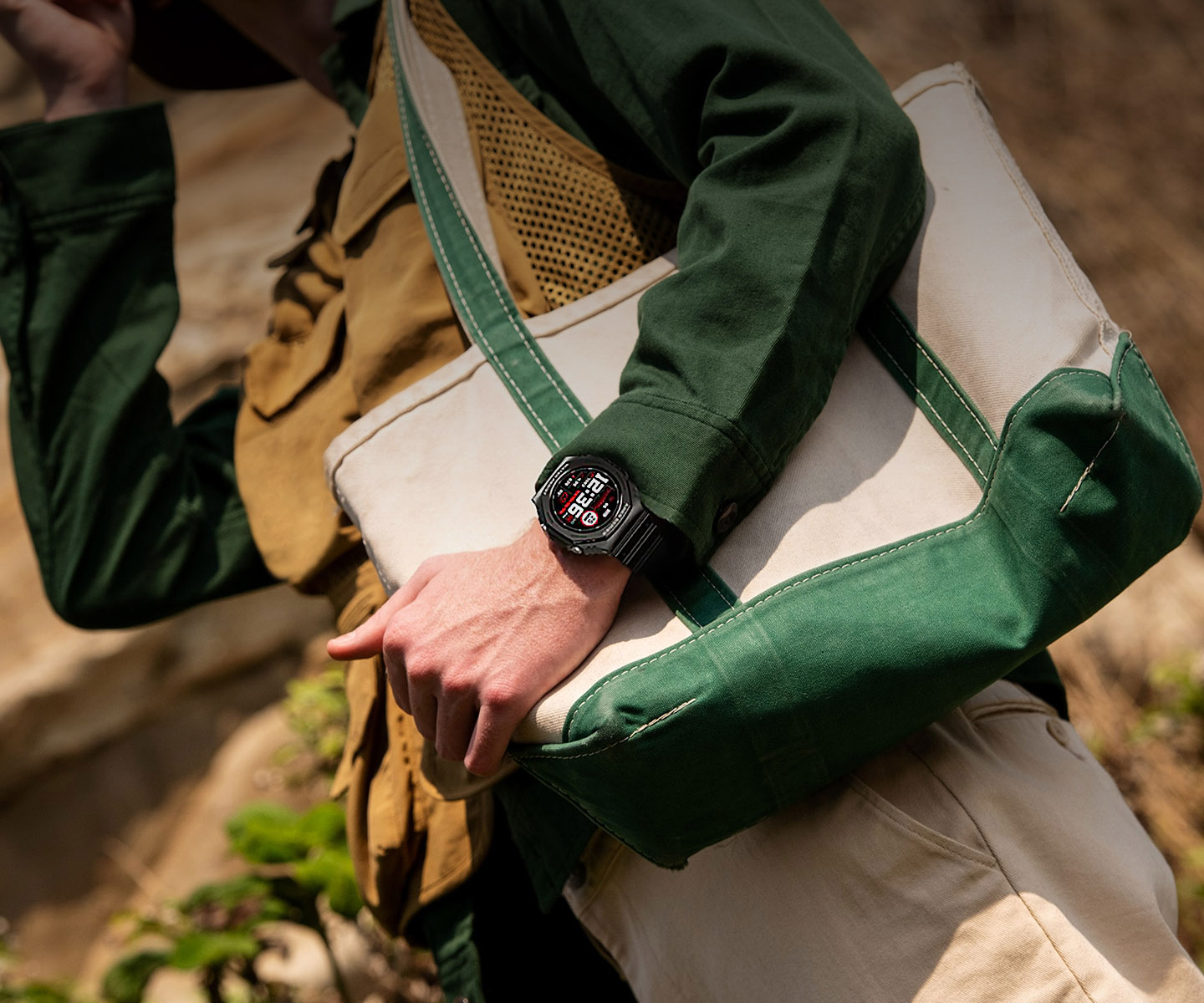 Smartwatch Zeblaze Ares 2 on the hand of a man in a green jacket