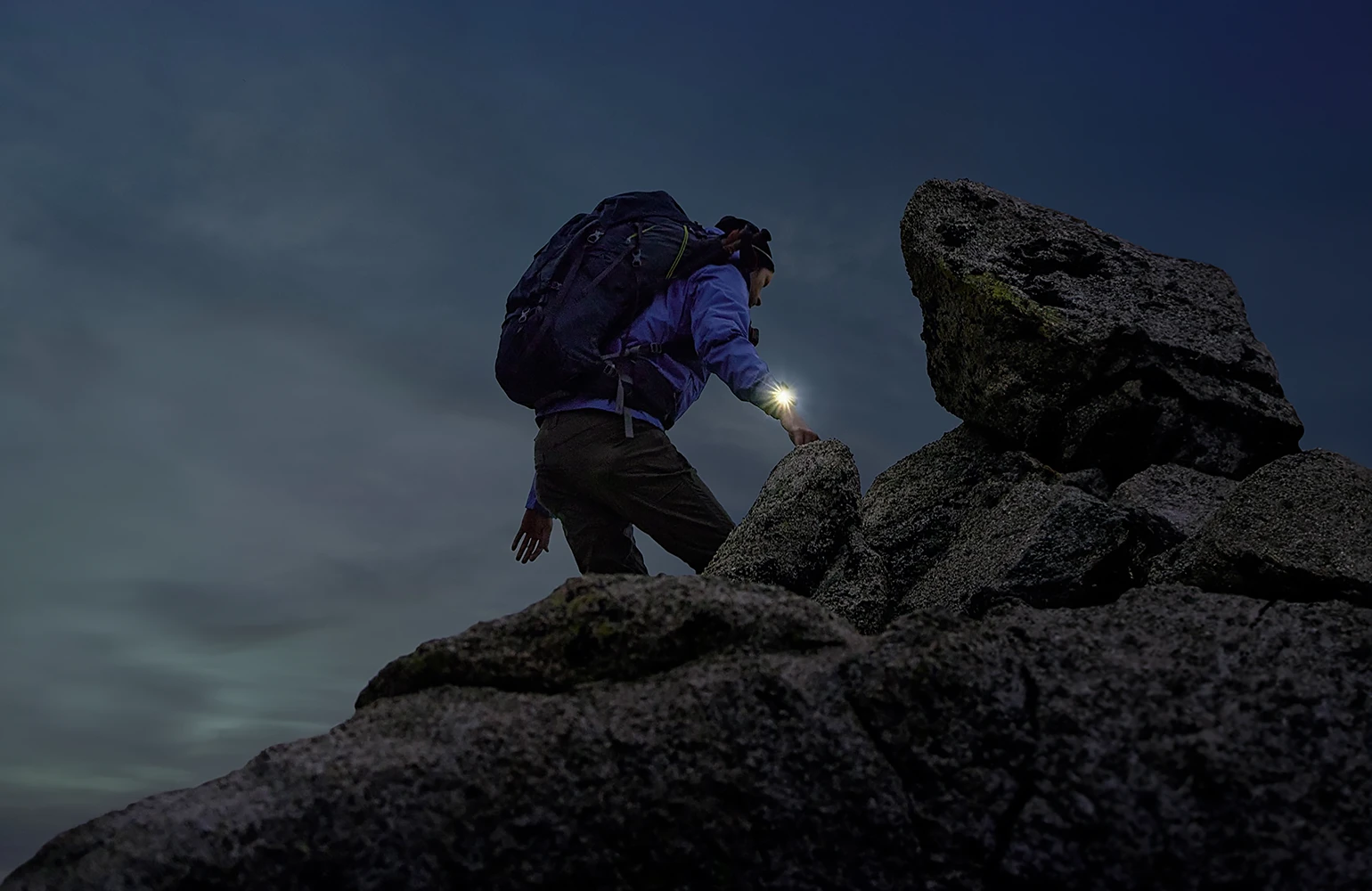 A man climbs a mountain wearing Zeblaze Stratos 4 smartwatch 